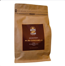 Load image into Gallery viewer, Pure Gold No. 4 medium roast Woke Living Coffee bag on a premium morning glow background