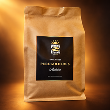 Load image into Gallery viewer, Pure Gold No. 6 dark roast Woke Living Coffee bag on a premium morning glow background